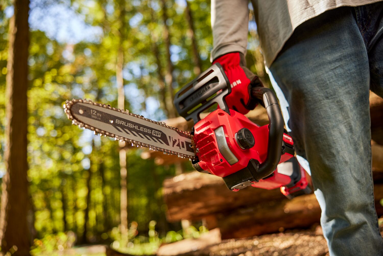 Zoom in of male holding V20 chainsaw 