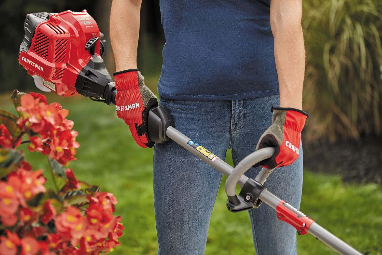 W S 2200 weedwacker 25 C C 2 cycle 17 inch attachment capable straight shaft gas trimmer being carried by a person.